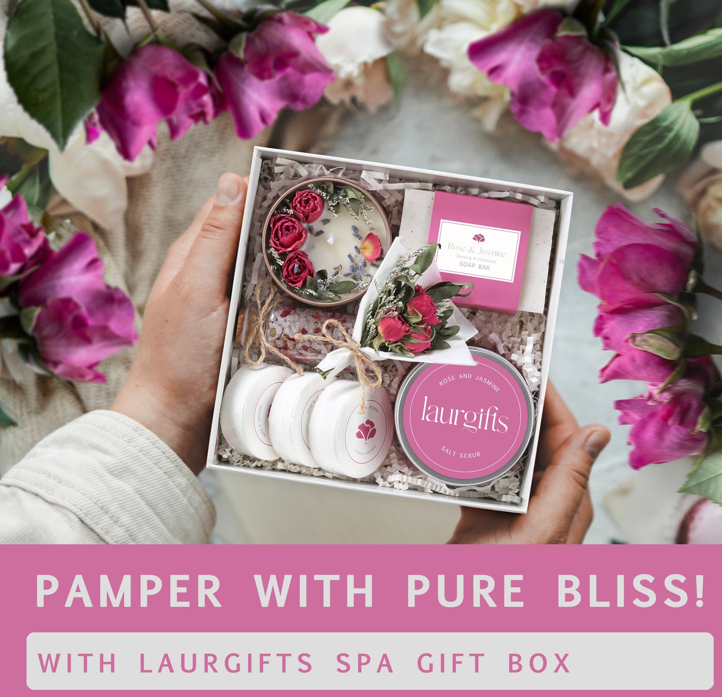 Hand holding a Laurgifts spa gift box with flowers in the background