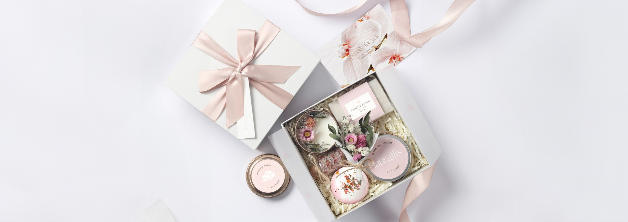 Floral-themed spa gift baskets for women with self-care products and pink spa items