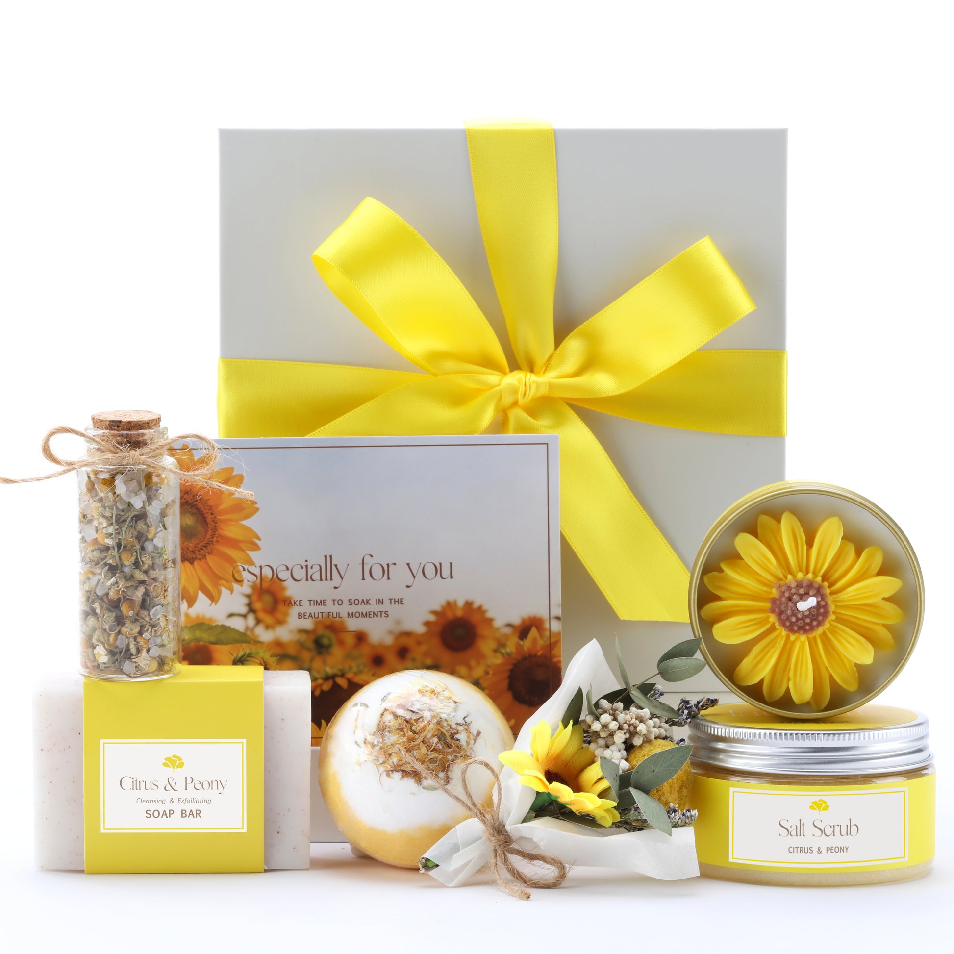 Gift set with sunflower-themed products including a candle, soap bar, and decorative items on a white background.