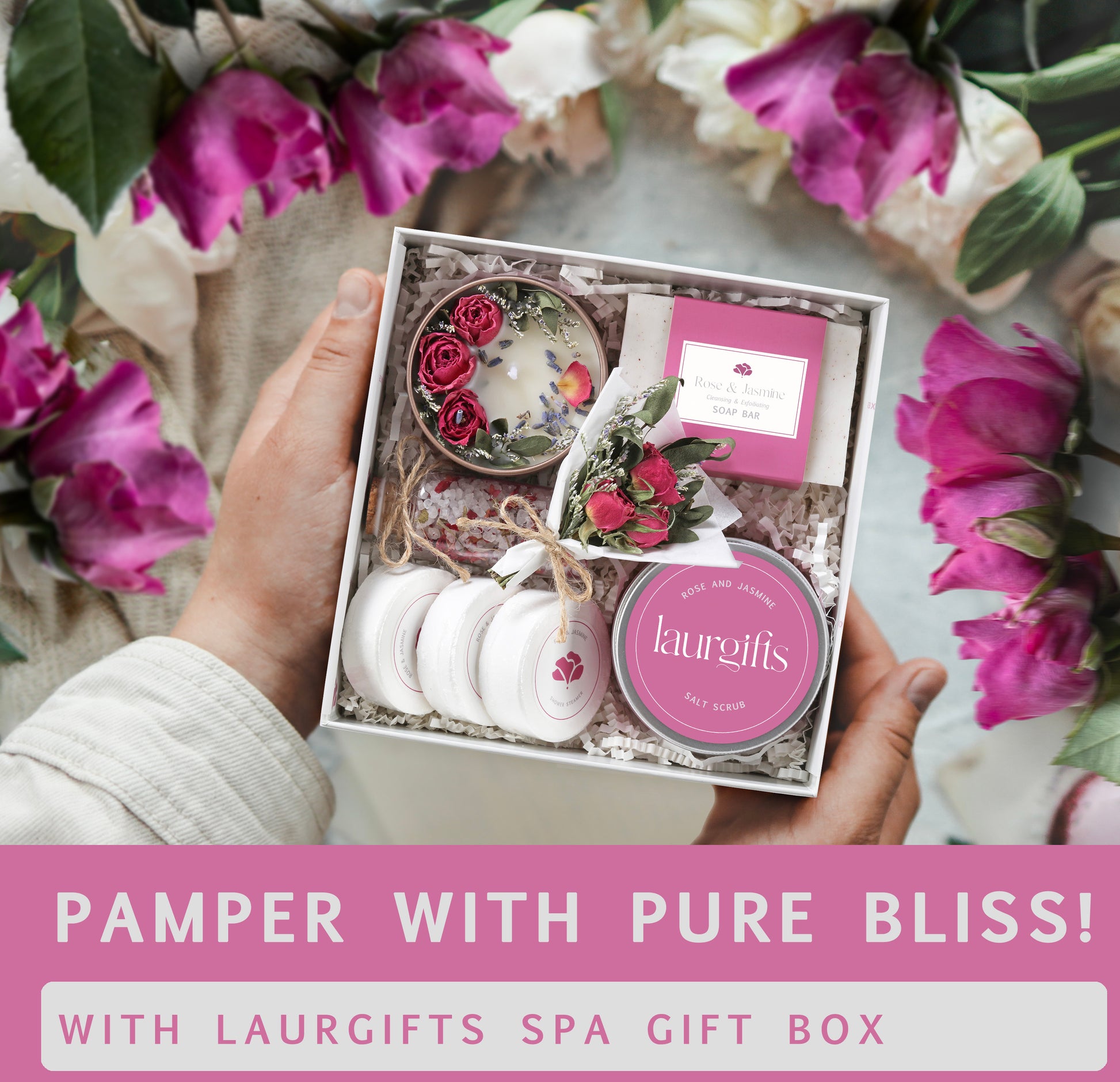 Hand holding a Laurgifts spa gift box with flowers in the background