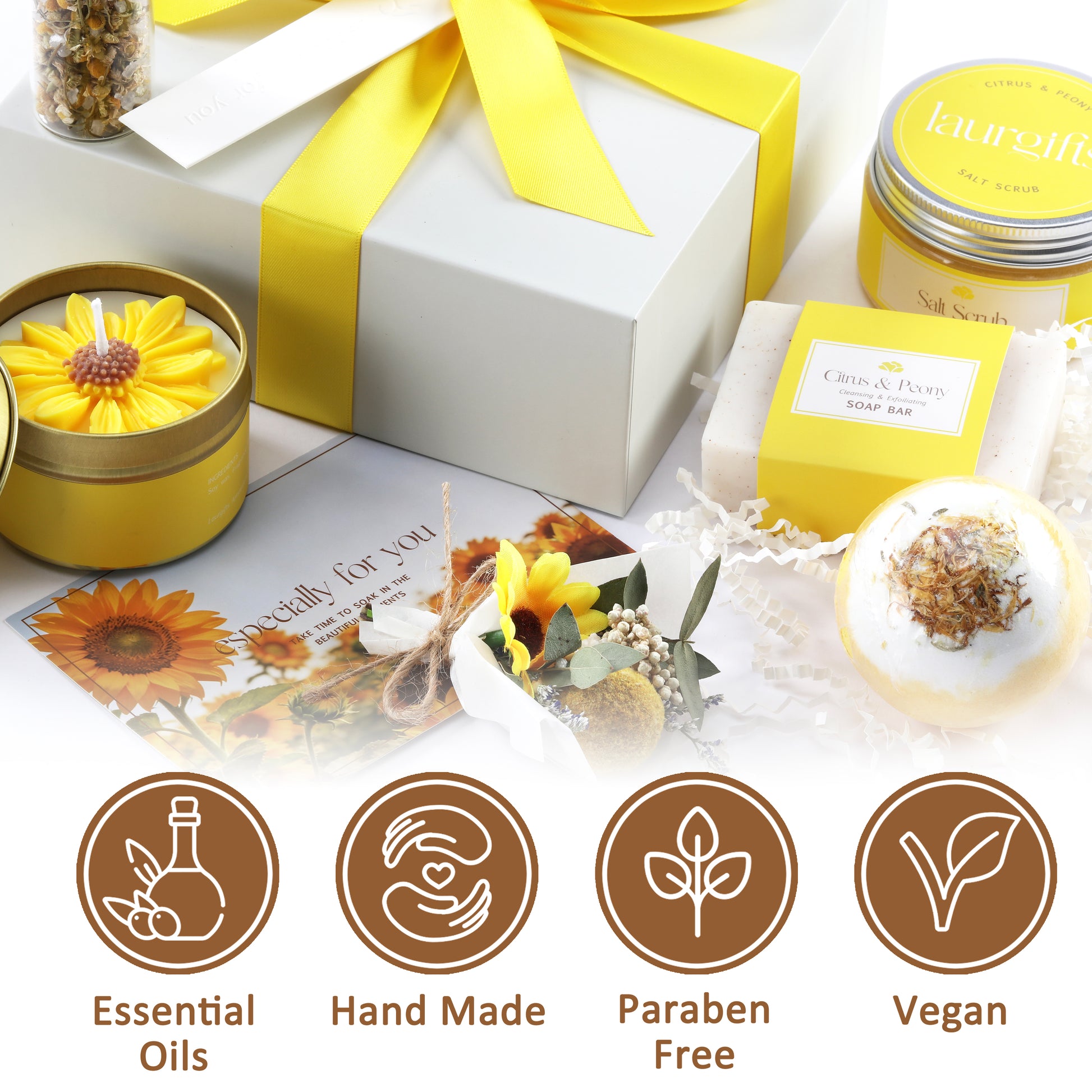 Gift set with candles, bath bombs, and a card on a white background, featuring icons for essential oils, hand made, paraben free, and vegan.